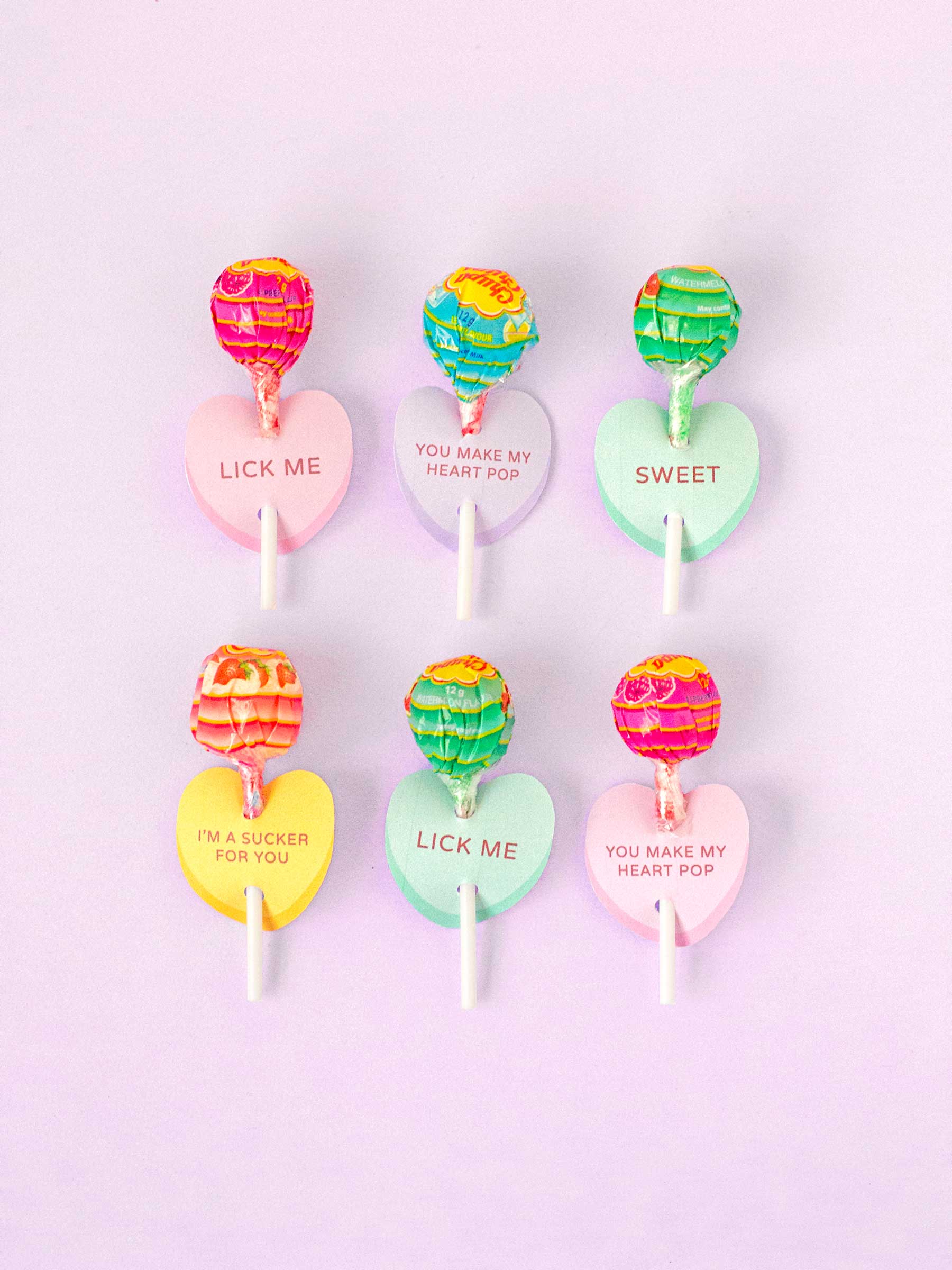 Photo of printable lollipop cards in the shape of conversation heart candy.